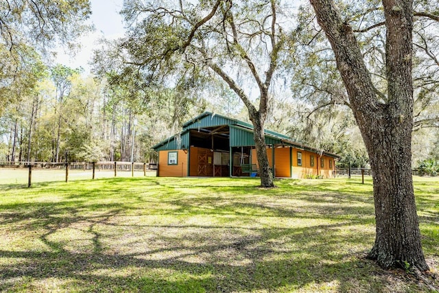 view of yard with an outdoor structure and fence