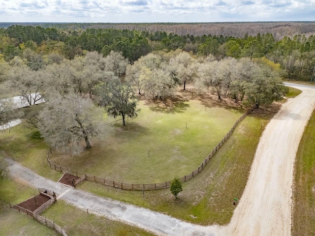 drone / aerial view featuring a forest view and a rural view