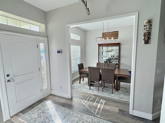 entryway featuring baseboards and wood finished floors