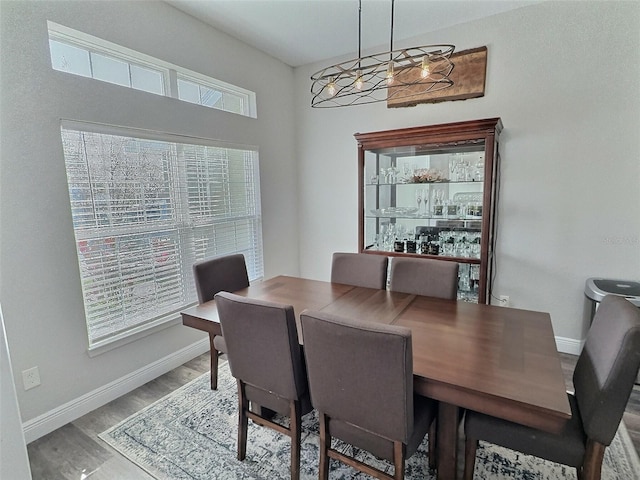 dining room featuring a wealth of natural light, baseboards, and wood finished floors