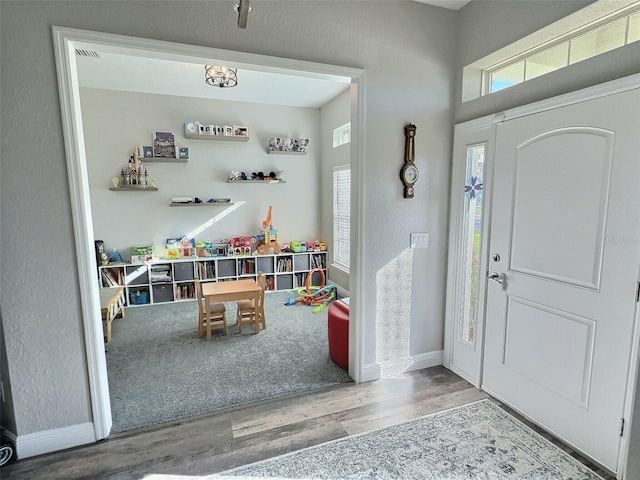 entryway featuring baseboards and wood finished floors