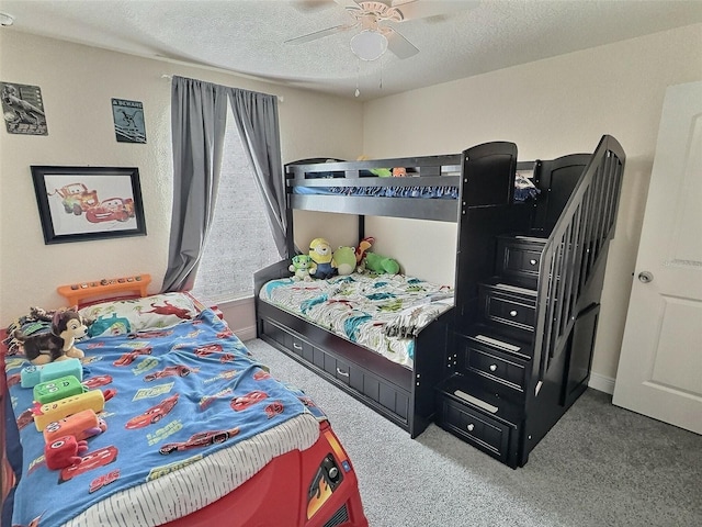 carpeted bedroom with baseboards, a textured ceiling, and a ceiling fan