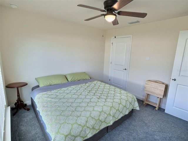 bedroom with a ceiling fan, baseboards, and carpet floors