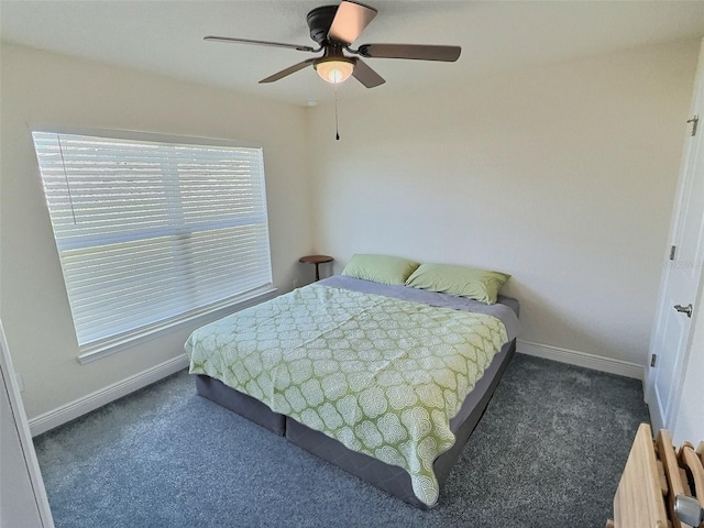 bedroom with radiator, baseboards, carpet, and a ceiling fan