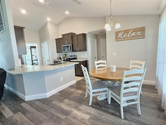 dining room with visible vents, baseboards, high vaulted ceiling, an inviting chandelier, and dark wood-type flooring