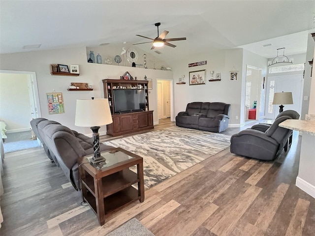 living area with ceiling fan, baseboards, lofted ceiling, and wood finished floors