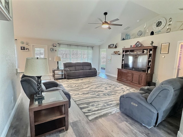 living area featuring vaulted ceiling, visible vents, ceiling fan, and wood finished floors