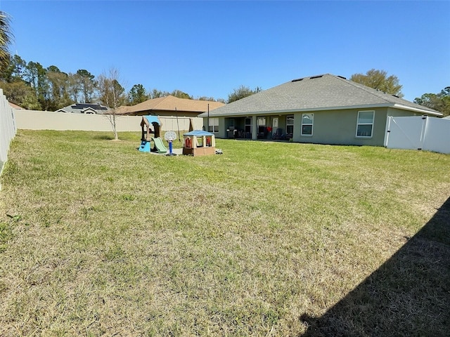 view of yard featuring a gate and a fenced backyard