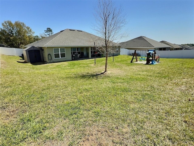 view of yard with a fenced backyard and a shed