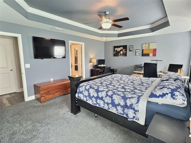 bedroom featuring a ceiling fan, visible vents, baseboards, ornamental molding, and a raised ceiling