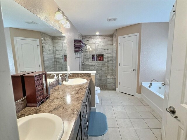 1034 SE 65th Cir, Ocala, FL 34472 - bathroom featuring tile patterned floors, double vanity, a shower stall, a bath, and a textured wall