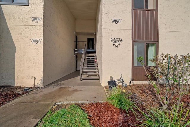 entrance to property featuring stucco siding