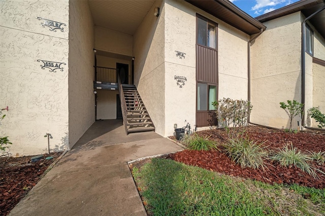 doorway to property with stucco siding