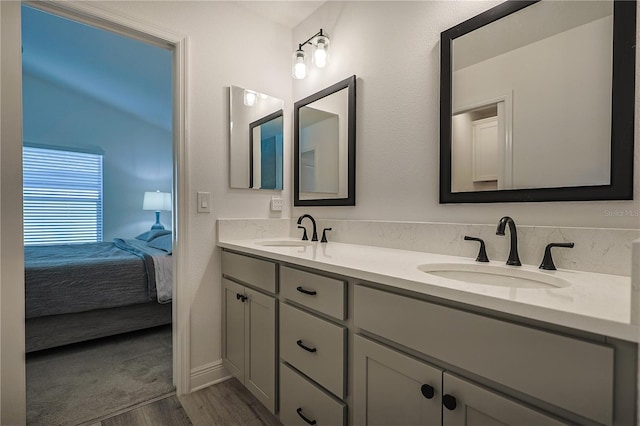 7014 Elaine Ct, The Villages, FL 34762 - bathroom featuring ensuite bath, wood finished floors, double vanity, and a sink