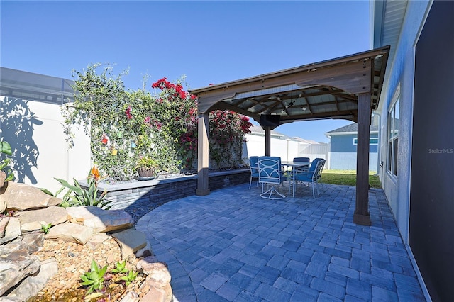 7014 Elaine Ct, The Villages, FL 34762 - view of patio with a gazebo, a fenced backyard, and outdoor dining space