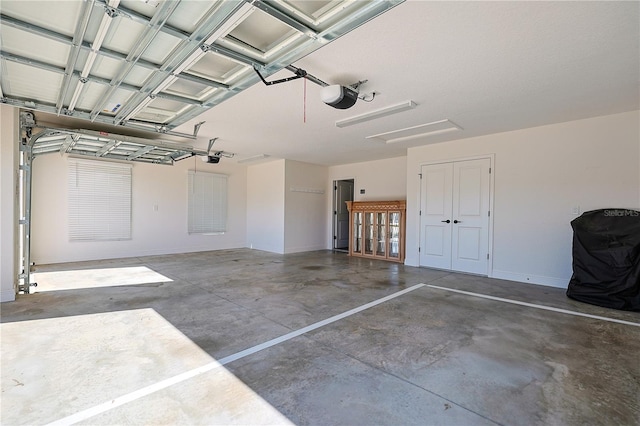 7014 Elaine Ct, The Villages, FL 34762 - garage featuring a garage door opener and baseboards