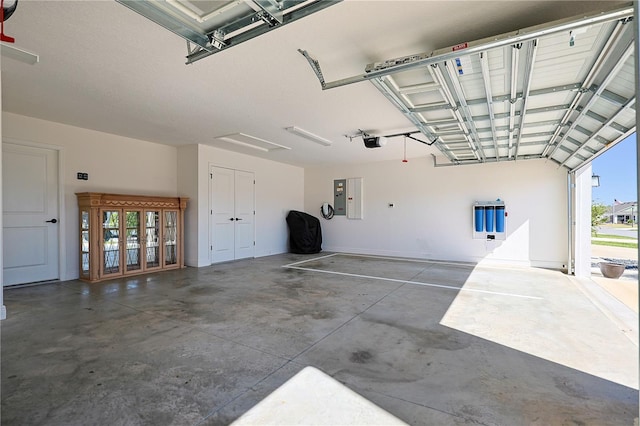 7014 Elaine Ct, The Villages, FL 34762 - garage featuring electric panel and a garage door opener