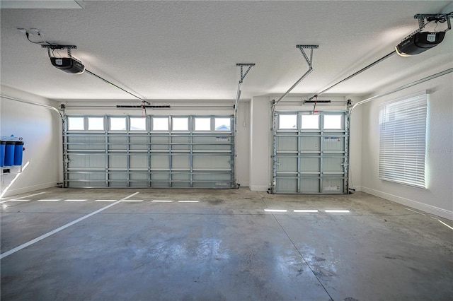 7014 Elaine Ct, The Villages, FL 34762 - garage featuring a garage door opener and baseboards