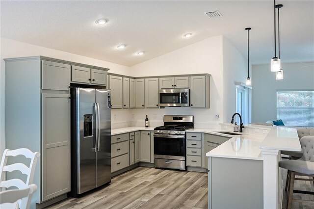 7014 Elaine Ct, The Villages, FL 34762 - kitchen featuring a peninsula, gray cabinets, appliances with stainless steel finishes, and a sink