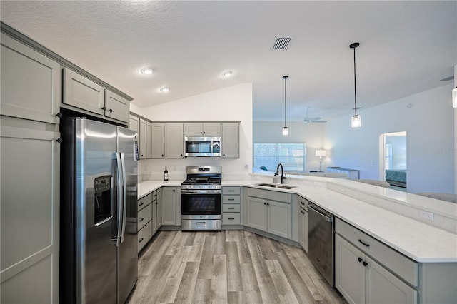 7014 Elaine Ct, The Villages, FL 34762 - kitchen with visible vents, a peninsula, gray cabinets, a sink, and stainless steel appliances