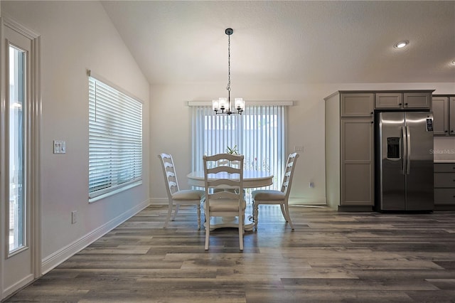7014 Elaine Ct, The Villages, FL 34762 - dining area with baseboards, lofted ceiling, a notable chandelier, and dark wood-type flooring