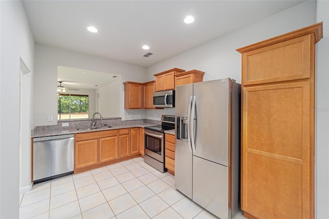 kitchen featuring light stone counters, visible vents, recessed lighting, a sink, and appliances with stainless steel finishes