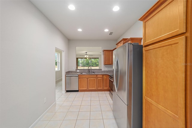 kitchen featuring light tile patterned flooring, recessed lighting, appliances with stainless steel finishes, and a sink