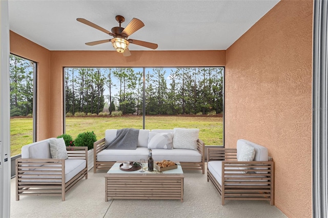 sunroom featuring a ceiling fan