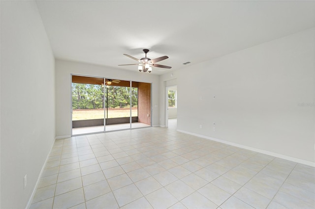 unfurnished room featuring baseboards, visible vents, and ceiling fan