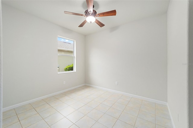 spare room with baseboards and a ceiling fan