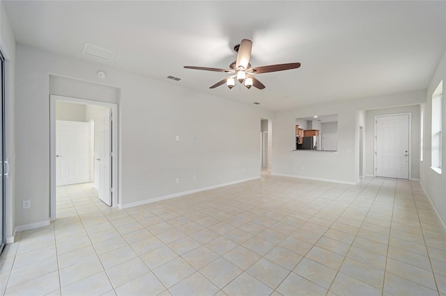 unfurnished living room featuring light tile patterned flooring, baseboards, and a ceiling fan