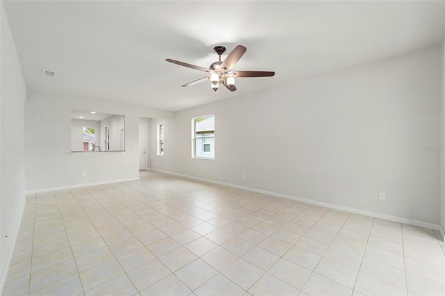 unfurnished living room with light tile patterned flooring, baseboards, visible vents, and ceiling fan