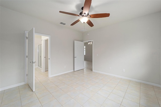 unfurnished bedroom with light tile patterned floors, visible vents, ceiling fan, and baseboards