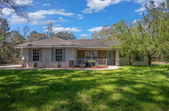 back of house with covered porch, a lawn, stone siding, and stucco siding