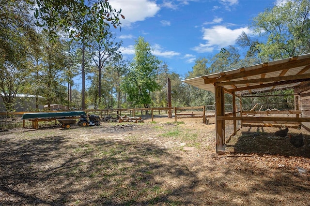 view of yard featuring an outdoor structure and fence