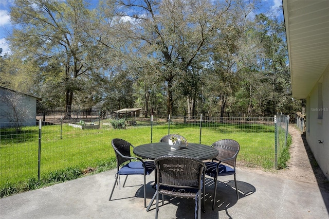 view of patio featuring outdoor dining space and fence