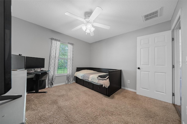 bedroom featuring visible vents, baseboards, a ceiling fan, and carpet flooring