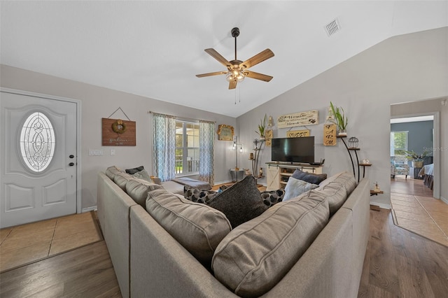 living room featuring visible vents, wood finished floors, a ceiling fan, and vaulted ceiling