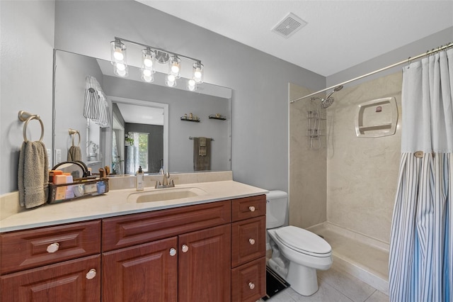 bathroom featuring vanity, a shower with curtain, visible vents, tile patterned floors, and toilet