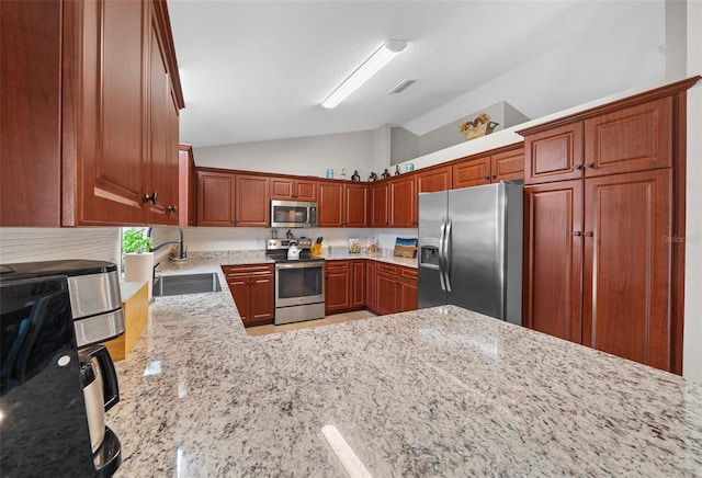 kitchen with visible vents, a sink, light stone counters, stainless steel appliances, and vaulted ceiling