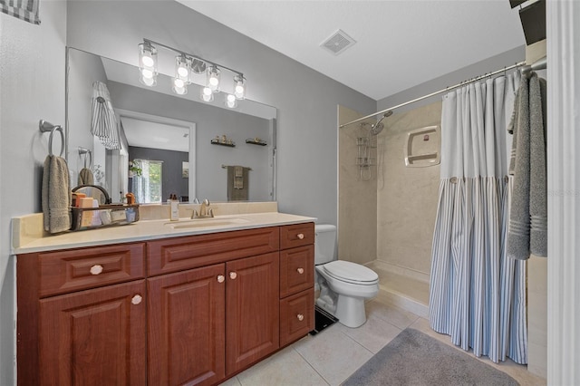 full bath featuring visible vents, toilet, tile patterned flooring, tiled shower, and vanity