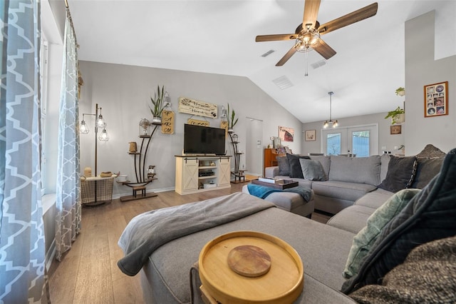 living room with visible vents, ceiling fan, vaulted ceiling, hardwood / wood-style floors, and french doors