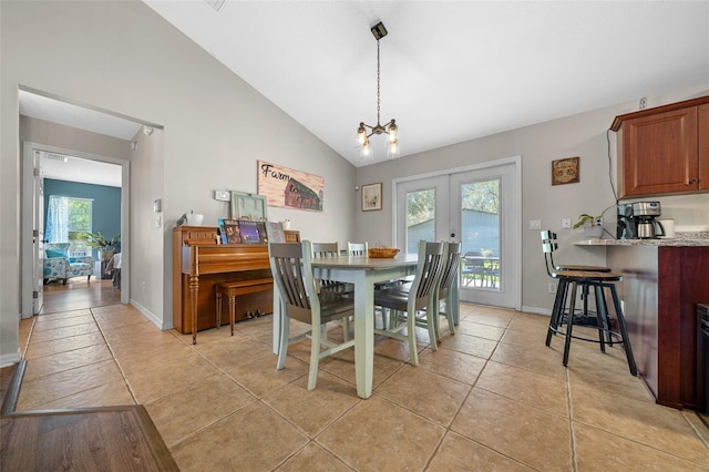 dining area with an inviting chandelier, light tile patterned flooring, french doors, and baseboards