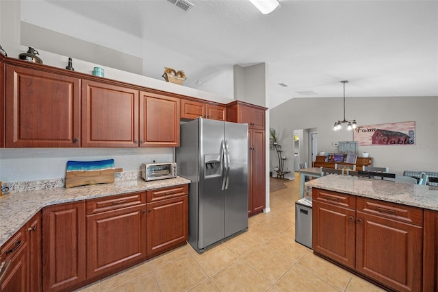 kitchen with light tile patterned floors, visible vents, lofted ceiling, stainless steel fridge with ice dispenser, and decorative light fixtures