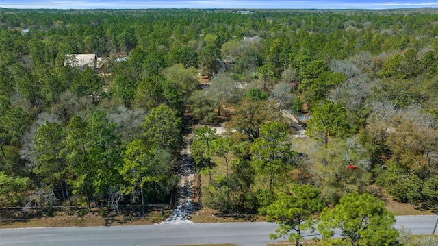 birds eye view of property with a view of trees