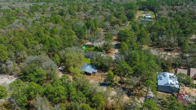 birds eye view of property with a forest view