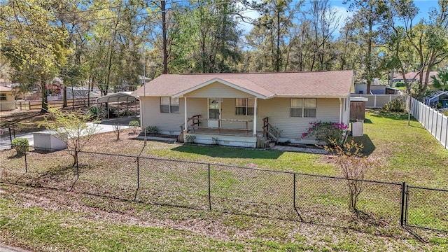 view of front of property with a carport, covered porch, a fenced backyard, and a front yard