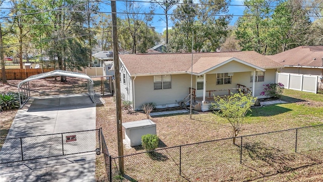 view of front of home with a fenced front yard, a carport, a porch, and driveway