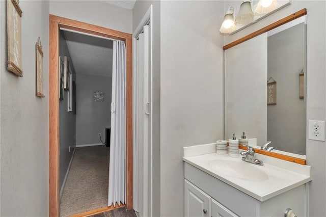 bathroom with vanity and baseboards