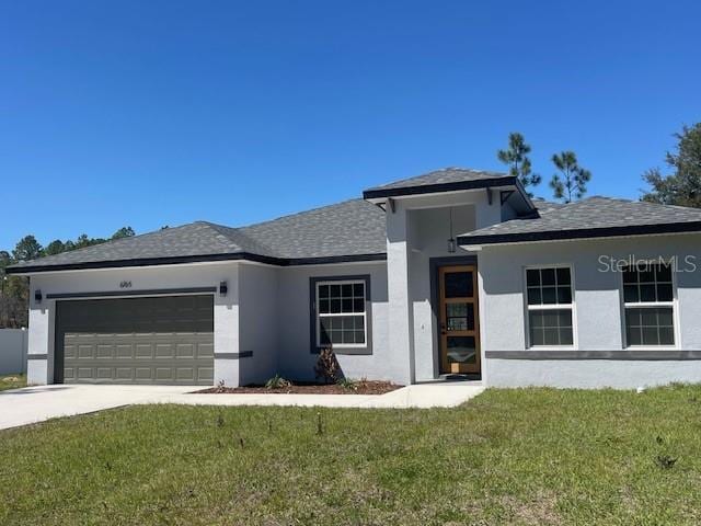 view of front of property featuring a garage, a front lawn, and stucco siding